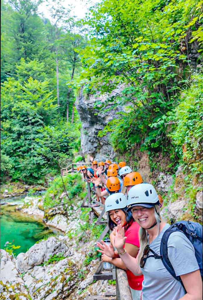 women waving on boardwalk at vintgar gorge