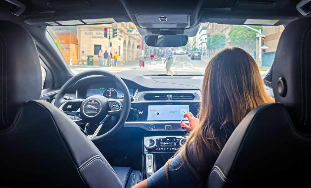 girl sitting in front of waymo