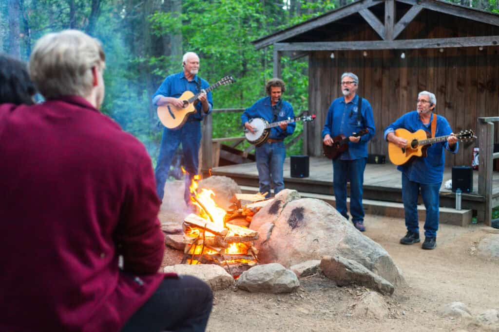 band playing around the campfire